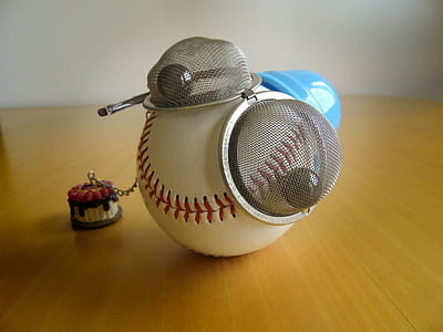 white and red baseball on brown wooden planks thumbnail