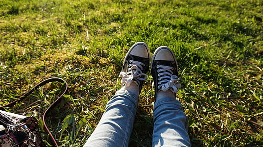 person wearing pair of black low-top sneakers thumbnail