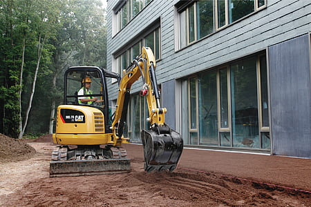 man using black and yellow excavator thumbnail