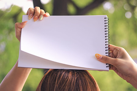 person holding white plain paper thumbnail