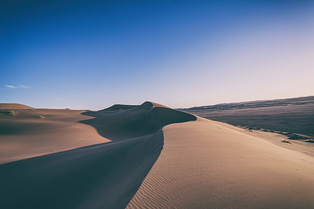 desert field under blue sky during daytime thumbnail