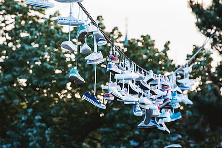 Shoes hanging on a line at city park. Prague, CZE thumbnail