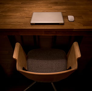 brown swivel armchair in front of silver laptop thumbnail
