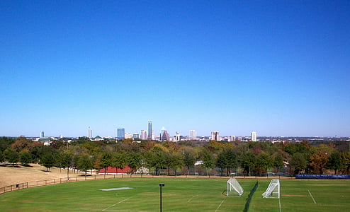 green game field under clear blue sky thumbnail