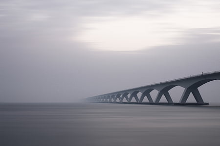 gray bridge on body of water thumbnail