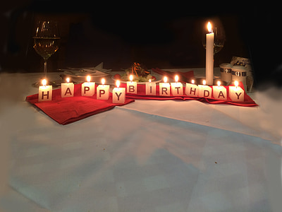 happy birthday candles on red textiles thumbnail