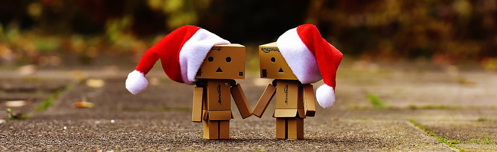 selective focus photography of two cardboard box robots wearing Santa hat thumbnail