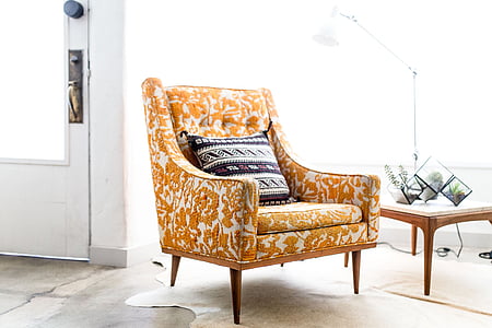 yellow and white floral sofa chair near door thumbnail