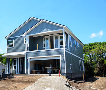 blue and white wooden 2-storey house beside trees thumbnail