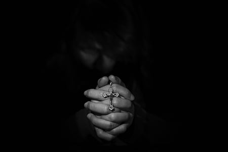 closeup grayscale photography of person's hand holding rosary thumbnail