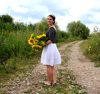 woman carrying basket of sunflowers thumbnail
