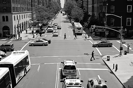 Greyscale Photo of Car and People on Streets thumbnail