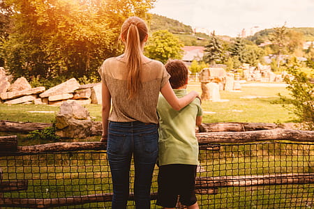 Two siblings next to each other in the park at summer thumbnail