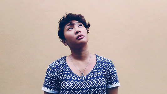 woman near wall looking upward thumbnail