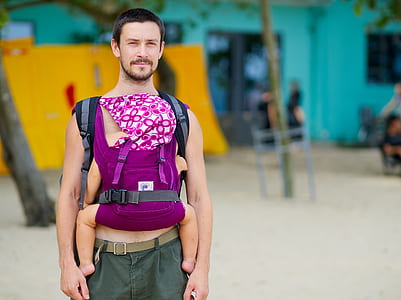 man carrying baby on beach thumbnail