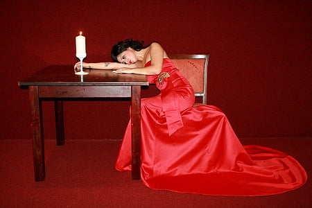 woman wearing red gown sitting on chair thumbnail