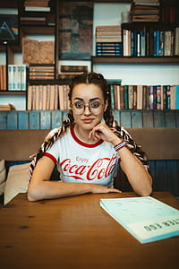 smiling woman sitting on chair in library thumbnail