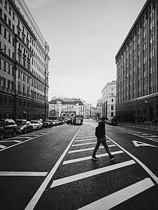 man crossing street photo thumbnail