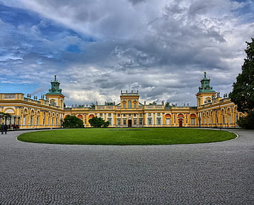 yellow castle under blue and white cloudy sky during daytime thumbnail