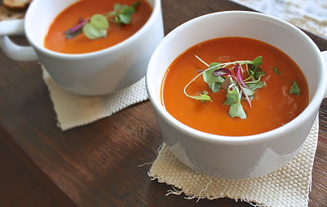 two round white ceramic bowls with sauce thumbnail