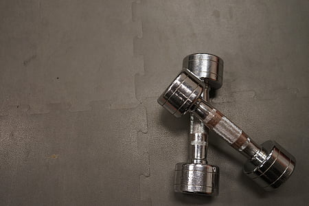 pair of grey fixed weight dumbbells on grey puzzle mat thumbnail