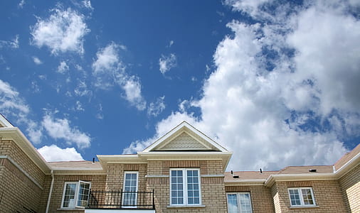 time lapse photography of clouds over house thumbnail