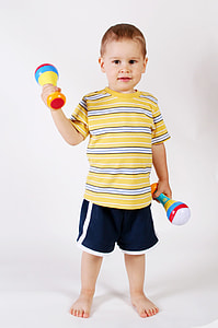 boy holding plastic toys thumbnail