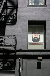 selective color photography of fear the beard sign in building thumbnail