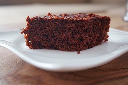 sliced of cake on ceramic coaster placed on wood plank thumbnail