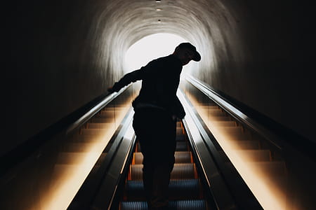 silhouette of man riding escalator thumbnail