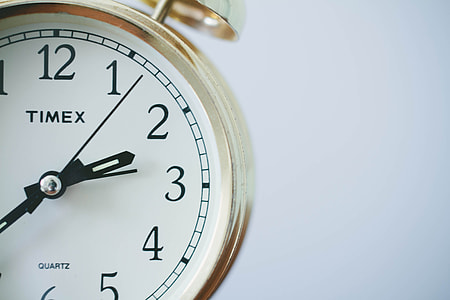 gold-colored Timex bell alarm clock around 2:33 thumbnail
