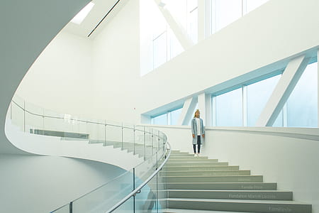 woman in blue coat standing on stairs thumbnail