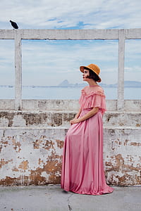 woman sitting on concrete staircase near body of water thumbnail