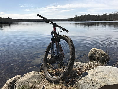 black hardtail bicycle beside body of water thumbnail