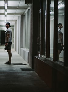 man standing near glass door thumbnail