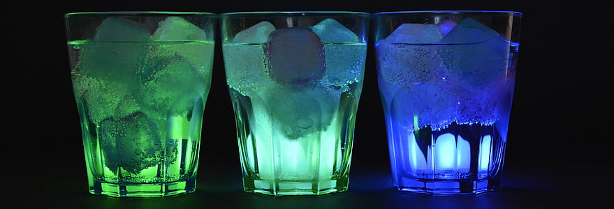 three rocks glasses filled with liquid and ice against black background thumbnail