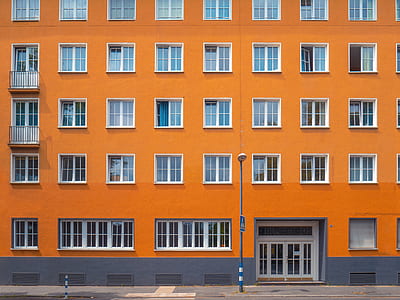 gray metal pole beside orange concrete building thumbnail