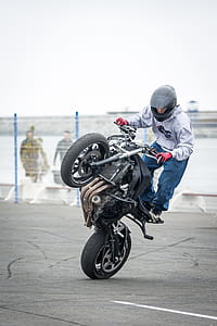 person riding black motorcycle during daytime thumbnail