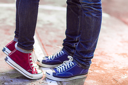 two person wearing blue denim jeans, blue and red high-top sneakers standing thumbnail