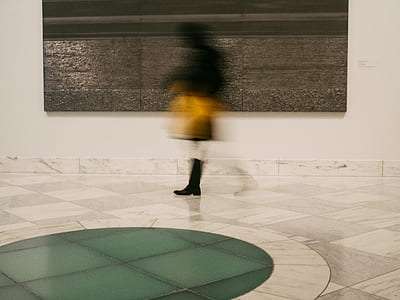 person standing on floor tiles in building interior thumbnail
