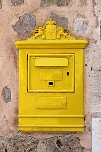 rectangular yellow metal box on brown concrete wall thumbnail