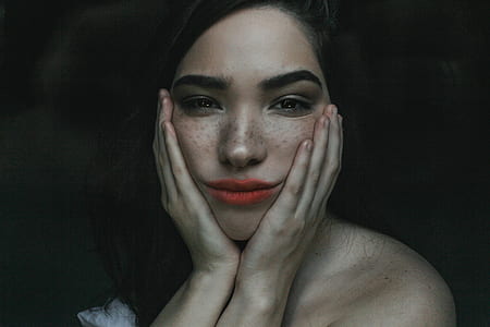 portrait photo of woman holding her cheeks thumbnail