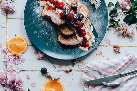 sliced bread with cream on top beside gray stainless steel butter knife and fork thumbnail