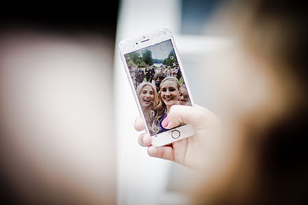 Selective Focus Photo of Gold Iphone 6 Displaying Two Women Taking Selfie thumbnail
