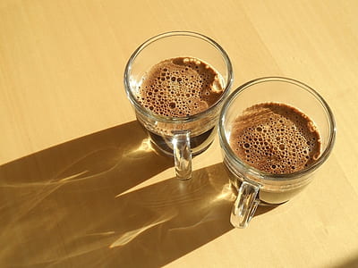 two clear glass mugs with chocolate drinks thumbnail