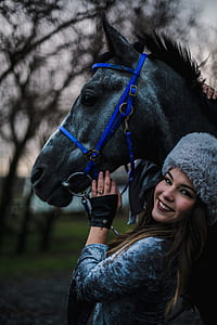woman holding black horse thumbnail