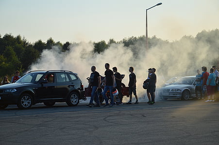 people standing beside of black car thumbnail