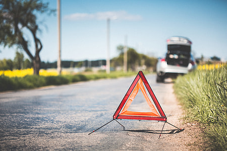 Red Warning Triangle and Broken Car on The Road thumbnail