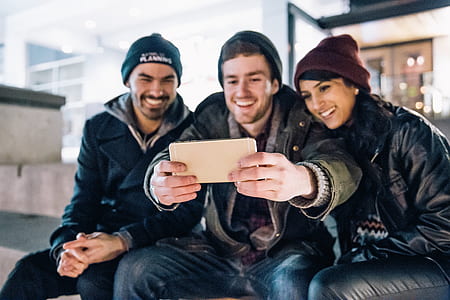 two men and woman taking picture thumbnail