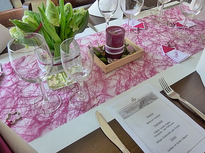 several empty wine glasses on top of white and pink table runner on top of table inside room thumbnail